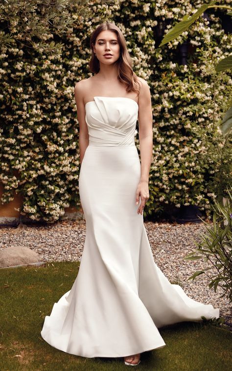 Wedding Dress Millie | EK1659 Mermaid gown in ivory satin with pleated bodice, detachable bow, buttons to end of train. Colors: Ivory Wedding Gown Accessories, Tiffany's Bridal, Eddy K, Wedding Dress Silhouette, Classic Wedding Decorations, Timeless Wedding Dress, Destination Dress, Designer Bridal Gowns, Winter Wedding Dress