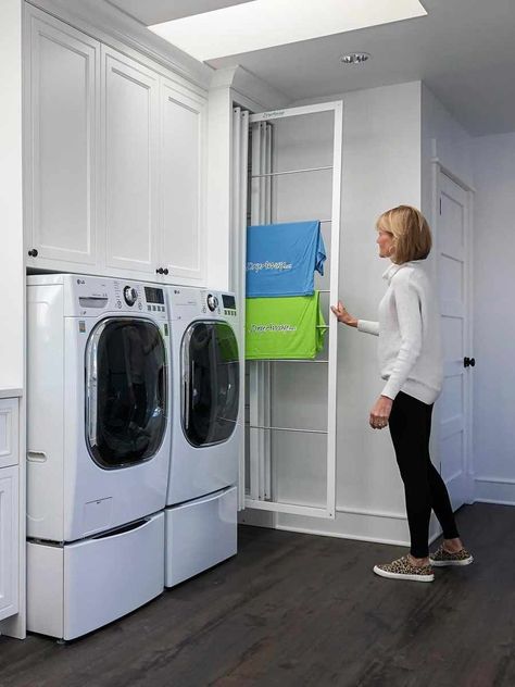 The DryAway allows you to completely forego the need for a laundry room. This company has created vertical drying racks you can slide in and out.The main advantage of DryAway is that it blends in with your decor. Thanks to a wide selection of sizes and colors, you to easily match these drying racks to your kitchen cupboards'. And with informative installation videos, you can have this brilliant idea for drying clothes in your home too. Sliding Clothes Drying Rack, Stacking Laundry Closet Ideas, Pull Out Drying Rack Laundry Room, Laundry Drying Cupboard Ideas, Drying Cabinet Laundry, Small Laundry Room Ideas With Hanging Space, Vertical Pull Out Drying Rack Laundry, Hidden Laundry Drying Rack, Small Laundry Drying Rack Ideas