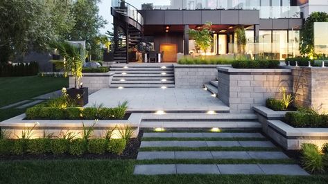 The top exterior home trends for 2023 | Techo Bloc Patio Paving, Patio Stone, Terraced Backyard, Garden Retaining Wall, Patio Slabs, Driveway Landscaping, Tiered Garden, Paving Slabs, Contemporary Homes