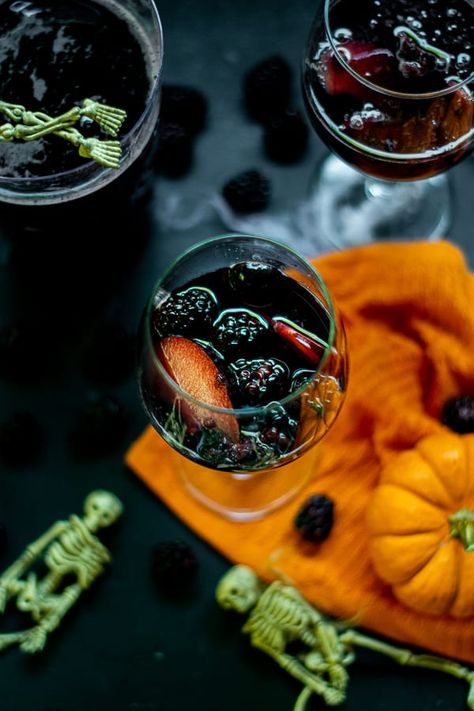 Not too sweet or overpowering this witch's brew Halloween Sangria Recipe is sure to please the adults on Halloween Night! This Black Red Wine Sangria is full of notes of blackberry and full of delicious black fruits to keep to theme. So have a Happy Halloween with this spooky Halloween Sangria! #halloweendrinks #halloweensangria #redwine #sangria #easy Halloween White Sangria, Black Halloween Food, Spooky Sangria, Witch Brew Sangria, Black Sangria Halloween, Blackberry Halloween Cocktail, Mummy Meatloaf, Blackberry Sangria, Black Plums