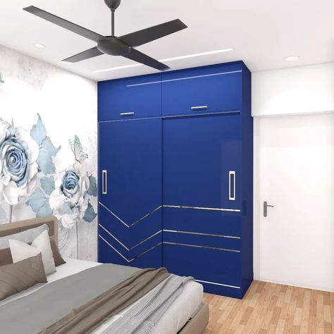 Blue themed bedroom - A blue HGL sliding wardrobe with a loft. All shutters have metallic gold handles which go along with golden designed T - patti (T joints) on the sliding door. Wardrobe size = 5x9 ft A floral wallpaper to compliment blue theme altogether. #interior #interiordesigner #interiors #decor #homedesign #homedecor #commercial #housedesign #luxuryhomes #interiör #interiør #luxurylifestyle #mumbai #instagram #instadaily #worklove #architect #home #interiordecor #interiordesignin... T Patti Wardrobe Door Design, Sliding Wardrobe With Loft, Wardrobe With Loft, Blue Themed Bedroom, Sliding Door Wardrobe, Wardrobe Door Designs, Golden Design, Themed Bedroom, Blue Theme