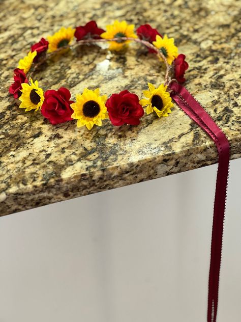 This listing is for one (1)  simple but pretty adjustable small open rose and sunflower  halo with long ribbon streamers available in your choice of ribbon colors. Burgundy ribbon shown.   Roses are available in red, off white and ivory.  If not specified, red roses will be used Shipping is via USPS first class mail insured.   Nothing pleases me more than when people share their pictures with me of people wearing my headpieces, corsages or using my kiss balls  I LOVE receiving pictures!   If you do share, WITH OUR PERMISSION ONLY,  I will give honorary mention - first name only as well as your photographer!  I do not share pictures of their faces unless I receive permission, especially of children, so be sure to tell me if it is okay.  Thank you for looking! Red And Sunflower Wedding, Rose And Sunflower Wedding Theme, Red And Yellow Wedding Theme, Sunflower And Burgundy Wedding, Burgundy And Sunflower Wedding, Rose Sunflower Wedding, Rose And Sunflower Bouquet, Sunflower Burgundy Wedding, Sunflower And Rose Wedding