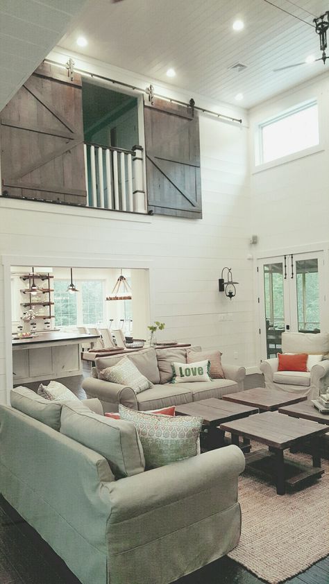 Living room with shiplap walls, lots of windows and barn doors on the loft! Loft Opening Ideas, Loft Above Dining Room, Private Loft Bedroom, Loft Looking Over Living Room, Open Staircase To Loft, Loft Renovation Ideas, Loft With Balcony, Adding Loft Over Living Room, Loft With Half Wall