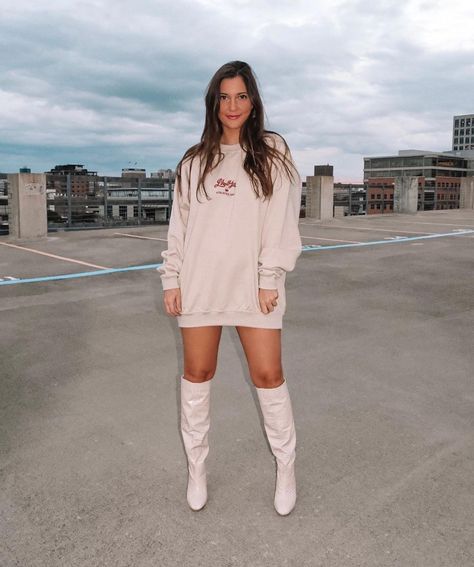 ALLY | FASHION & LIFESTYLE on Instagram: “took this sweatshirt from WFH to GNO 🤍 // linked sweatshirt, as well as the plain version, and boots on the blog! Link in bio —> shop my…” White Knee High Boots Outfit, Knee Length Boots Outfit, Dress And Tall Boots, Parking Garage Poses, Cream Boots Outfit, Garage Poses, Cream Knee High Boots, White Sweatshirt Outfit, Tan Boots Outfit