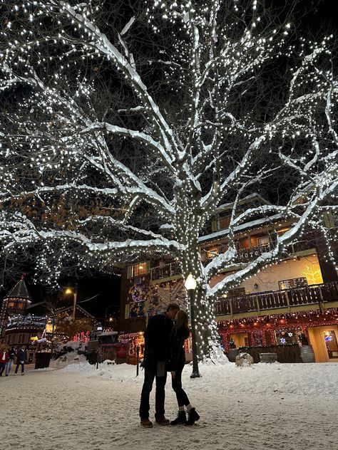 Christmas couple. Christmas tree. Christmas lights. Snow. Leavenworth. Christmas things. Travel. Holiday travel. Christmas town. Couple things. Kiss In Snow, Christmas Lights Couple Pictures, Romantic Christmas Aesthetic, Kissing In Snow, Christmas Romance Aesthetic, Couples Christmas Aesthetic, Winter Wonderland Couple, Christmas Lights Date, Kissing In The Snow