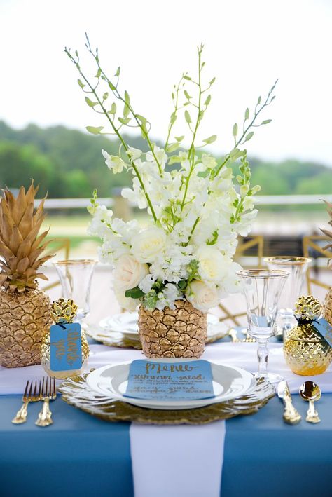 This centerpiece is made with real pineapples that were spray painted gold and stuffed with real flowers!  I've never seen anything like this.  It's stunning and so unique.  This is a great idea if you want to have a tropical wedding with a formal vibe. Destination Wedding Centerpieces, Fine Apple, Birdcage Decor, Tropical Arrangements, Tropical Wedding Centerpieces, Cuban Party, Pineapple Centerpiece, Pineapple Wedding, Palm Wedding