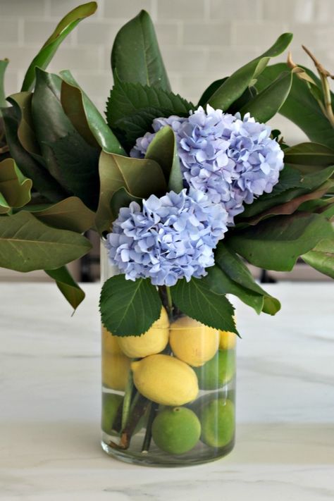 Citrus and Hydrangea Centerpiece  and of course some cute magnolia stems are the perfect finishing touch. Lemons and Limes are so great for a summer dinner party! Dinner Party Centerpieces, Hydrangea Flower Arrangements, Summer Flower Arrangements, Deco Kitchen, Hydrangea Centerpiece, Hydrangea Arrangements, Faux Hydrangea, Flower Vase Arrangements, Lemon Decor