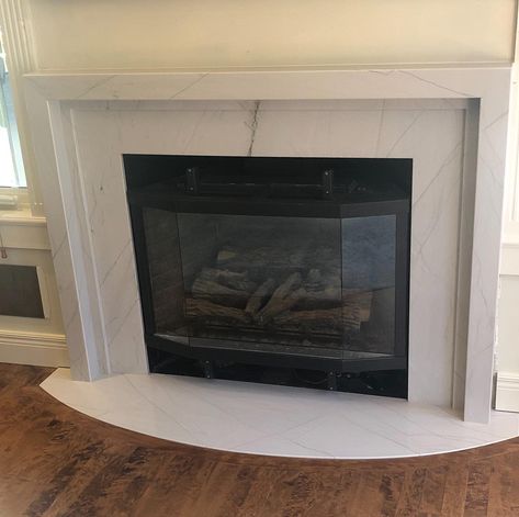 Gas Fireplace Surround Ideas Tile, Fireplace With Quartz Surround, Marble Fireplace Surround Ideas, Fireplace Granite Surround, Granite Surround Fireplace, White Marble Fireplace Surround, Porcelain Tile Fireplace Surround, Fireplace With Granite Surround, Update Gas Fireplace Surround