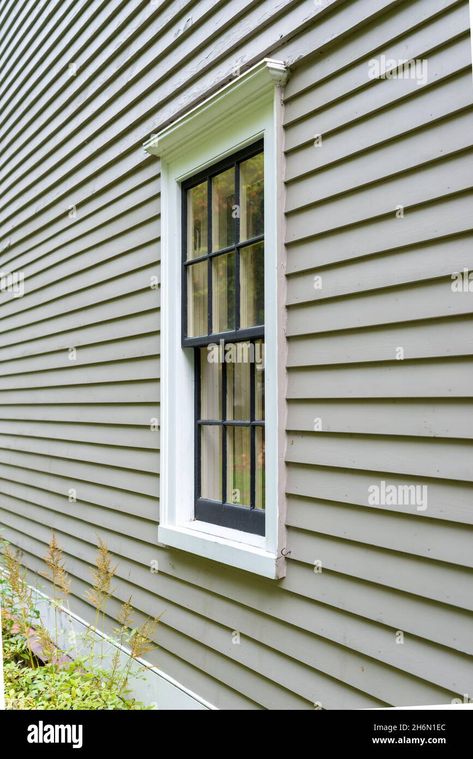 Download this stock image: Old tan colored house with white trim and black wood window frame spacers. The glass in the window is wavy and reflects the sun. - 2H6N1EC from Alamy's library of millions of high resolution stock photos, illustrations and vectors. House With White Trim, Window Seats Ideas, Wood Window Frame, Window Sill Decor, Clapboard Siding, Wood Window, Window Seats, Wood Windows, Buy Home