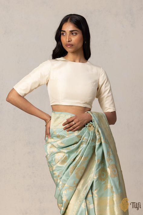 "A silken blouse with a chic silhouette. A modest and elegant zero-neck front and back, finished with a row of decorative potli buttons.\u00a0\n\n\n Color - A beautiful shade of Off-White.\u00a0 This design can also be made in a colour of your choice.\n\n\n Fabric - Pure Silk\u00a0\nPlease allow 10-12 business days for despatch.\u00a0\n\n" Modest Blouse Designs, Boat Neck Design, India Inspired, Diy Sewing Clothes, Sewing Clothes, White Fabrics, Silk Blouse, Boat Neck, Pure Silk