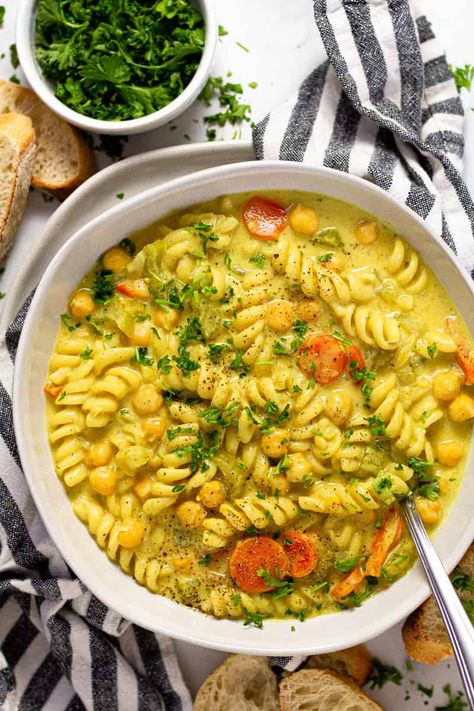 This creamy chickpea noodle soup is the best vegan comfort food you'll find on the internet! It's filled with pantry ingredients and loaded with warm, cozy, flavors that will have your family cleaning their bowls and asking for seconds! Chickpeas Meals, Wfpb Dinner, Chickpea Noodle Soup, Veggie Noodle Soup, Chickpea Noodle, Vegan Chicken Noodle Soup, Creamy Chickpea, Sauteed Carrots, Chickpea Soup