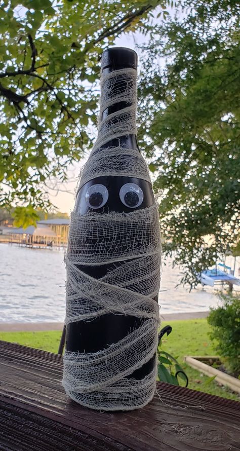 Wine Bottle Crafts For Fall, Wine Bottle Halloween Crafts, Halloween Wine Bottles Diy, Wine Bottle Fall Crafts, Wine Bottle Mummy, Halloween Lighted Wine Bottles, Diy Halloween Decorations Wine Bottles, Mummy Wine Bottle, Wine Bottle Halloween