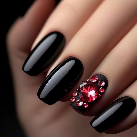 Black nails adorned with a shimmering red rhinestone Black And Red Nails With Rhinestones, Black Nails With Red Diamonds, Black Nails Red Rhinestones, Black With Red Sparkle Nails, Black Nails With Red Glitter Accent, Black Nail Art, Red Rhinestone, Valentine's Day Nails, Black Nails