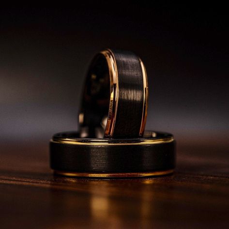 We are excited to present this bold black tungsten wedding band with 18k gold edges. Careful milling and craftsmanship are noticed throughout this wedding ring.HOW THE RINGS ARE MADE:-first this ring is milled from a perfectly square black tungsten block right down to a perfectly shaped ring-we then flip the ring vertically and carefully mill each side to a perfect 90 degree step edge and plate it with only the best 18k yellow gold-finally we sand, buff, and polish the ring so it has a brushed o Black Wedding Bands For Men, Black Gold Wedding Ring, Black Gold Wedding Rings, Wedding Ring Yellow Gold, Mens Wedding Rings Black, Black Wedding Ring, Wedding Ring Black, Wedding Band Men, Black Tungsten Wedding Band