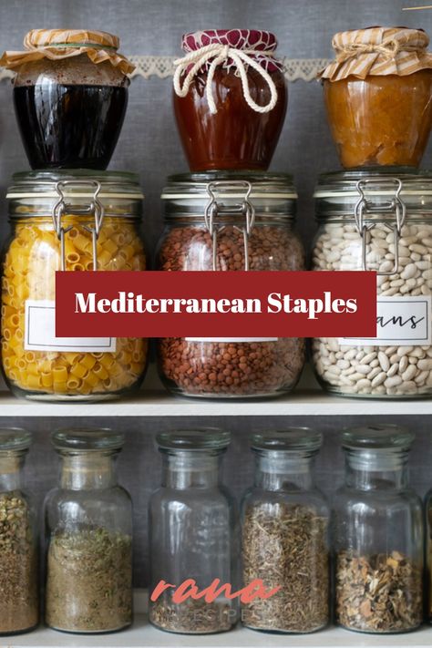 Close-up view of a pantry stocked with Mediterranean essentials like dry herbs, beans, pasta, and jams. Mediterranean Staples, Mediterranean Herbs And Spices, Mediterranean Pantry Staples, Mediterranean Diet Pantry Staples, Mediterranean Herbs, Mediterranean Pantry, Mediterranean Food List, Foods For Heart Health, Mediterranean Seasoning