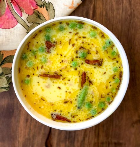 Gujarati Kadhi is a yogurt based sweet and spicy curry that is simple yet irresistible; it gets the sweetness from jaggery, the spice from cinnamon and the heat from green chillies and lends itself to a pure comfort meal.Kadhi goes well with any vegetable and especially when you have legumes as one of the main dishes. The yogurt-based gravy lightens the protein rich legumes, making you feel light after a meal.Gujarati Kadhi Recipe is traditionally served along with Khichdi and Aloo Shaak Gujarati Kadhi Recipe, Gujarat Food, Parsi Recipes, Gujarati Kadhi, Rajasthani Recipes, Kadhi Recipe, Yogurt Curry, Goan Food, Veg Recipes Of India