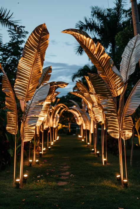 Make a Grand Entrance: Gilded Tropical Leaves & Candlelit Pathway Ideas  - Evening Wedding Ideas Indoor Tropical Wedding Ceremony, Elegant Tropical Party, Evening Wedding Ideas, Tropical Glam Decor, Glam Party Decor, Tropical Gala, Golden Wedding Decor, Island Wedding Ideas, Reception Venue Decorations