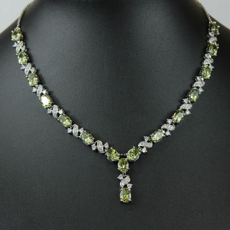 "WHITE GOLD FINISH Created Diamond Peridot \"Love and Kisses\" Necklace, Part of the Love and Kisses Collection This stunning green necklace is hand finished with beautiful peridot stones and created diamonds. It's a sophisticated touch to any look making you look elegant and graceful. Peridot, the bright green colour of nature, is associated with harmony, good health, restful sleep, and peacefulness. Known as the stone of compassion, peridot calms anger by giving renewal to all things. When set in gold, this gem was said to protect the wearer from nightmares. Beautifully designed to make a wonderful moment into a truly amazing moment and a special gift for that someone special. You are already beautiful; this piece will simply adorn your own inner beauty and reflect your decorated eleganc Luxury Elegant Peridot Jewelry, Luxury Peridot Necklace, Peridot Jewelry Set, Peridot Jewelry Necklaces, Love And Kisses, Queens Jewels, Peridot Birthstone, Love And, Peridot Jewelry