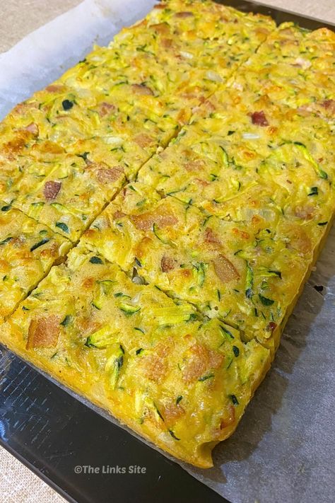 Delicious and versatile, this quick Zucchini Slice recipe is perfect for using up those extra zucchinis! Enjoy it hot or cold, any time of day. Breakfast, lunch, or dinner, it's a winner! Zucchini Slice Recipe, Ham Zucchini, Easy Zucchini Slice, Double Chocolate Zucchini Muffins, Potato Zucchini, Chocolate Zucchini Muffins, Ham Potato, Slice Recipe, Cheese Puff Pastry