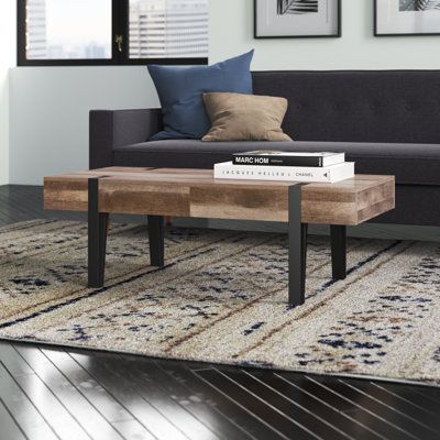 This coffee table elevates your living room with an industrial-inspired, modern look. It's crafted in a rectangular shape from engineered wood in a light oak hue that has a natural look. The design features four oversized iron hairpin legs with brackets at the top in a contrasting stark, black color. We love that it also has two drawers great for storing the remote control or for tucking away surface clutter before company comes over. At about 4' long, it's the perfect size to accompany standard Couch Colors, Table Wood Metal, Living Room Essentials, Austin Design, Metal Coffee Table, Pedestal Dining Table, Coffee Table Wayfair, Table Wood, Hairpin Legs