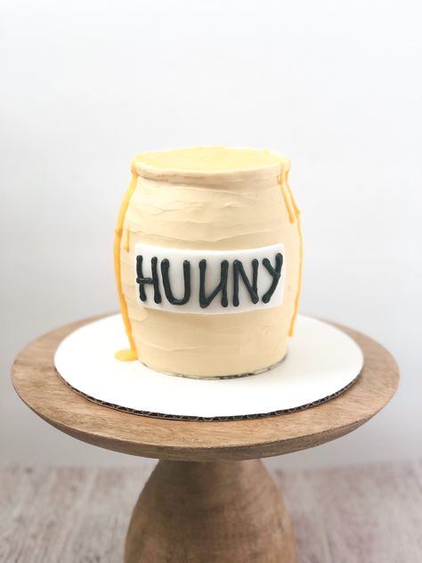 Honey Pot smash cake perfect for a little ones 1st birthday party! Honey Smash Cake, Our Little Hunny Turns One, Pooh Bear Cake Smash, Pooh Bear Smash Cake, Beehive Smash Cake, Honey Pot Smash Cake, Winnie The Pooh Smash Cake 1st Birthdays, Honey Pot Cake, Pooh Smash Cake