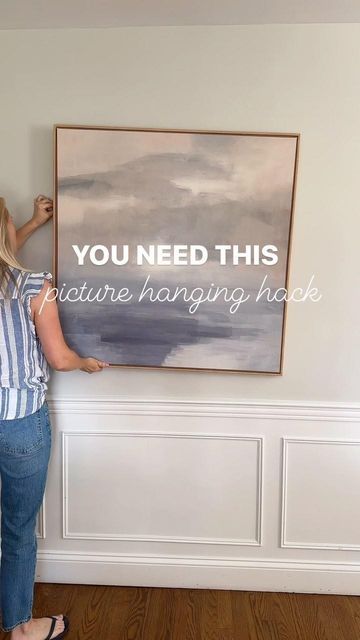 Jenna Shaughnessy on Instagram: "You need this picture hanging hack! - Place painters tape from hook to hook on the picture - Using a pencil, make a hole where each hook is - Mark the center point of the picture directly on the tape so you can position the picture correctly on the wall - Next, draw a level line on the wall where you want the picture to hang - Transfer the tape to the level line - Hammer nails where the the holes in the tape are - Remove the tape and hang the picture The re How To Hang Pictures On Wall, Cedar Garland, Shea Mcgee, Long Pictures, Hang Pictures, Norfolk Pine, Picture Wire, Center Point, Picture Hook