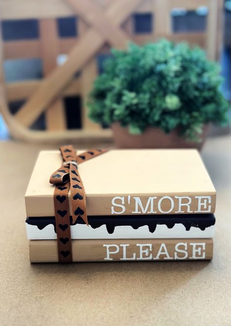 "S'more Please wooden book stack. This adorable farmhouse book stack is perfect for your summer tiered tray decor.  Book stack measures approximately 5\" x 3\" x 3\" and are painted with ribbon added. Blocks are glued together. IMPORTANT NOTICES: By submitting your order, you agree to all shop policies, thank you! I use a third party app to make the QR codes. I am not responsible if there site is down. I will have your message stored indefinitely and it will work again as soon as their site is back up and running! 1. Our processing time varies seasonally, you can see our current processing time by checking the \"shipping & policies\" tab located in this listing, Please be aware that processing time does not including shipping time, so please add 3-5 business days on top of processing time. Stacked Wooden Books Diy, Book Stack Decor Diy, Mini Wood Books Diy, Wooden Book Decor, Halloween Stacked Books, Dollar Tree Tiered Tray Diy, Diy Book Stacks, Summer Crafts To Sell, Fall Book Stacks