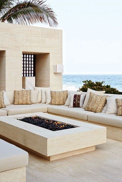 OUTDOOR LIVING ROOM: Made of niwala limestone from Spain, the outdoor living room’s seating is topped by cushions clad in a Ralph Lauren Home fabric. Overlooking the sea. Living Area, Palm Trees, Outdoor Living, The Beach, Trees