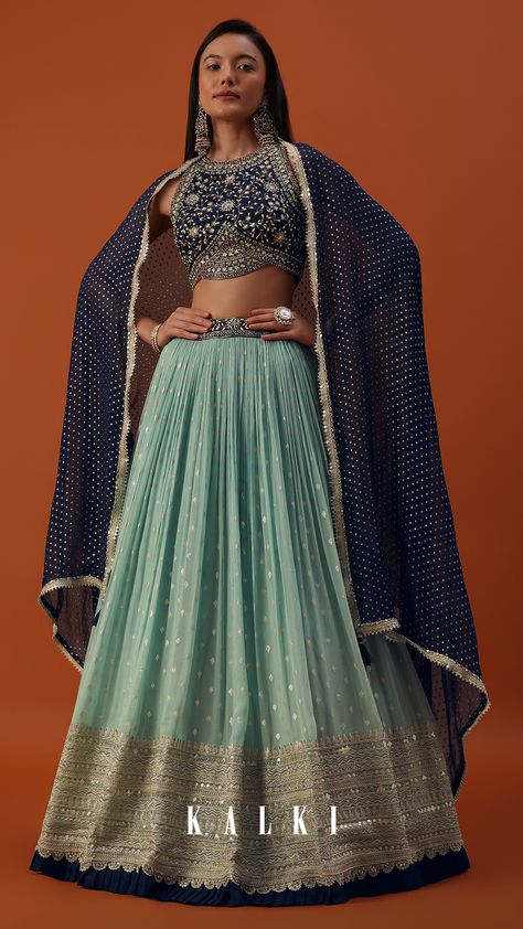 "Introducing our sky blue georgette lehenga and blouse set with brocade buttis. This ensemble is adorned with sequins, cut dana, zari, beads, mirror, and stone work. The silk blouse features a high-halter neckline. The set comes with a matching dupatta and attachable short sleeves.. EVENT - Ideal for sangeet and wedding functions." Teal Colour Lehenga, Blue Georgette Lehenga, Sky Blue Lehenga, Lehenga Skirts, Pleated Lehenga, Lehenga And Blouse, Saree Party, Cape Top, Georgette Lehenga