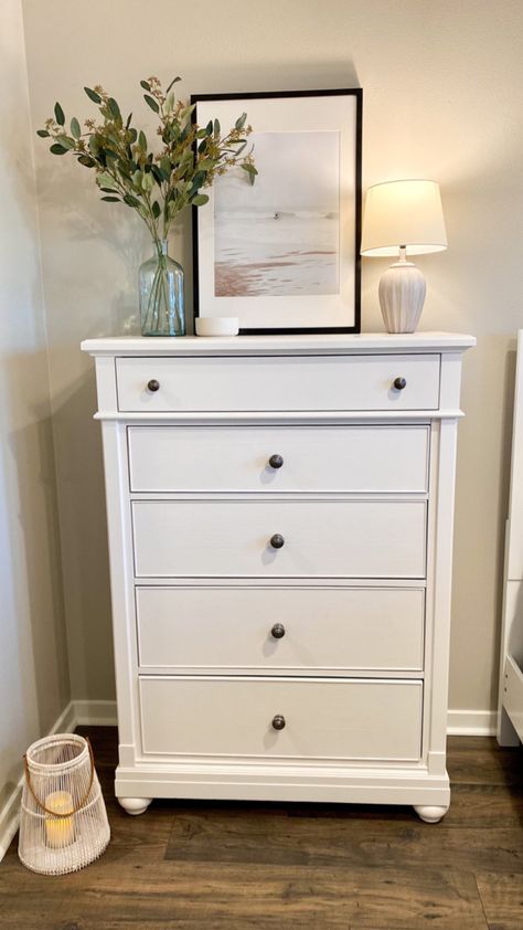 #talldresserdecor #bohocoastal #bedroomdecor #bedroomideas #moderncoastaldecor #coastalbedroom #decor #interiordecorating Vertical Dresser Decor, Style Tall Dresser Top, White Dresser In Living Room, Styling A Tall Dresser Top, Chest Of Drawers Top Decor, Y’all Dresser Decor, Art Above Tall Dresser, Tall Dresser Ideas Bedroom, Talk Dresser Decor