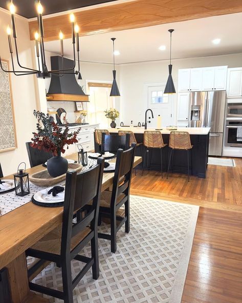 If you wish for a subtle separation between an open-concept kitchen and dining room, consider an exposed wood beam to define the borders of each space without adding a wall. This works well if the walls are a light color, then the beam will contrast strongly and create a visual break in the room. These adjoining spaces share a love of black accents and natural wood tones. Shared Kitchen And Dining Space, How To Separate Living And Dining Room, Beam Between Kitchen And Living Room, Open Concept Kitchen Dining Room, Kitchen Dining Room Combo, Rent House, Concept Kitchen, Wood Beam, Dining Room Ceiling