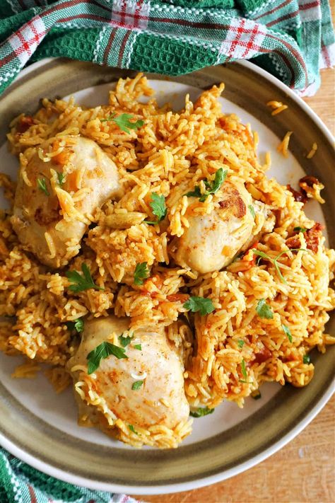 Chicken Kabsa, an Arabian one-pot chicken and rice dish that is incredibly fragrant, with juicy chicken thighs and perfectly fluffy basmati rice cooked in earthy spices that elevate this dish and make it truly unique. It's a very popular dish in many Middle Eastern countries, particularly Saudi Arabia, where it is considered the national dish. Easy to make, a fantastic exotic dinner with a spicy kick. Middle Eastern Countries, Juicy Chicken Thighs, Chicken And Rice Dishes, Broccoli Rice Casserole, Visual Recipes, Middle Eastern Dishes, Eastern Countries, One Pot Chicken, National Dish