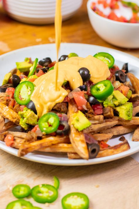 These vegan, gluten-free, nut-free, and oilfree Nacho Fries are healthy but they sure don't taste like it! My most-requested family favorite, these loaded crispy fries are easy to make in the oven or airfryer! #vegan #nachos #fries #airfryer #frenchfries #zardyplants Nachos With Queso, Queso Nachos, Nacho Fries, Potato Nachos, Vegan Queso, Vegan Nachos, Queso Recipe, Vegan Potato, Vegan Main Dishes