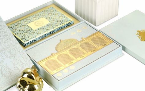 This blue laser cut box is as sleek and smart as they come. Adorned with a very intricate Mughal style jali at the top and brass corners, its appeal is Wedding Box Design, Indian Wedding Invitation Box, Invitations Card Design, Wedding Invitations Card, Top Wedding Registry Items, Crea Cuir, Box Wedding Invitations, Gold Leaf Design, Unique Wedding Cards