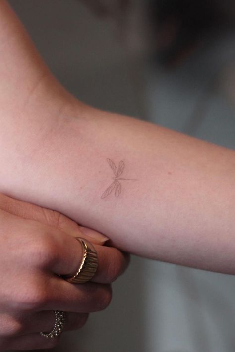 40 Awesome Dragonfly Tattoo Design Ideas Wrist Tattoos Dragonfly, Cool Fineline Tattoo, Dragonfly Tattoo Aesthetic, Elegant Tattoo Placement, Dragonfly Tattoo Forearm, Wings Tattoo On Back Small, Brown Fine Line Tattoo, Fineline Dragonfly Tattoo, Dragonfly Tattoo Fine Line