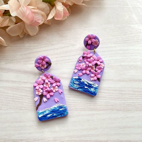 Purple sakura earrings. Last pair left. Probably retiring this design. I always like to try new designs 😆 Sakura Earrings, Purple Sakura, Clay Artist, Asian Aesthetic, Purple Earrings, Clay Ideas, Artist On Instagram, Polymer Clay Crafts, New Designs