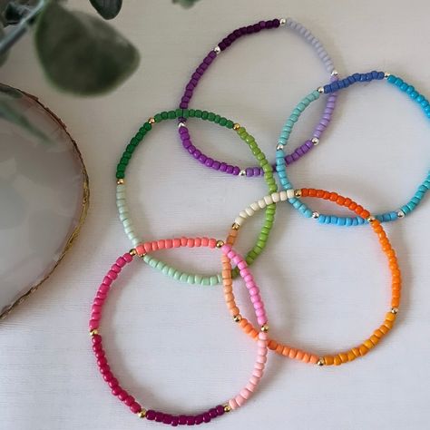 Small colourful beaded bracelets made with 4mm seed beads. Perfect gift for friends, Mother's Day, sisters, birthdays, spring and summer. Choose from gold or silver plated detailing. Sizing: All bracelets come in a choice of 15cm (extra small), 16cm (small), 17cm (medium) or 18cm (large). It is suggested you measure your wrist to check size using a piece of string or measuring tape. If you are not sure, 17cm is a standard recommended average adult size. Instructions for care: Please note bracelets are made with a stretch material so should be rolled onto wrist to put on and take off. Do not get bracelets wet or pull excessively on them. Bead colours may fade over time. SAFETY: These bracelets are intended for adults/older children only and not suitable for very young children. Keep out of Seed Bead Charm Bracelet, Summer Bracelets Seed Beads, Dainty Beaded Bracelets, Bracelet Ideas Seed Beads, Small Bead Bracelets Ideas, Bracelets Rainbow, Bracelets Dainty, Small Bead Bracelet, Diy Beaded Rings