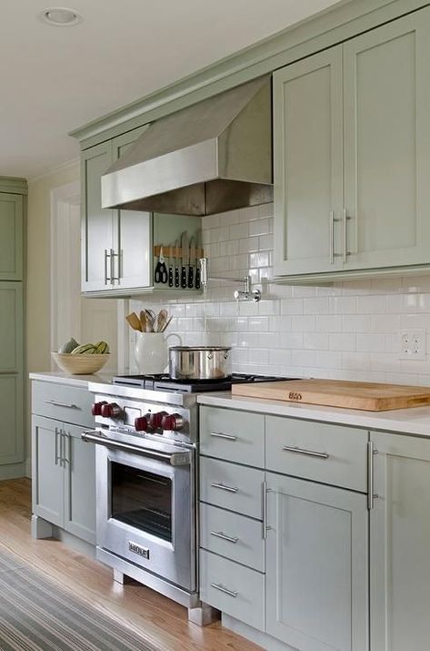 Soothing green kitchen features sage green cabinets paired with white quartz countertops and a white subway tiled backsplash. Sage Kitchen, Sage Green Kitchen, Kitchen Green, Green Kitchen Cabinets, Farmhouse Kitchen Cabinets, New Kitchen Cabinets, Green Cabinets, Kitchen Cabinet Colors, Backsplash Ideas