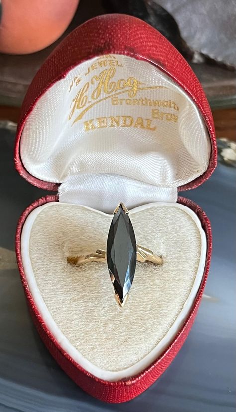 Item: Vintage Mid Century 10K Gold Black Alaskan Diamond Hematite Navette Ring. This is stamped and tested 10K gold. Black Alaskan Diamond is the trade name for Hematite. The ring box shown in the photos is not included in the sale of the ring. Measurements: Size 7.75. It weighs 2.77 grams.  Condition: Vintage, previously owned. Under magnification there are a couple of tiny pin prick sized nicks on the facets. Nothing major. There are other very minor signs of age/use/patina. Please see our other listings, we combine shipping for savings. Navette Ring, Ring Box, 10k Gold, Last Minute Gifts, Rings Statement, Gold Black, Statement Rings, Patina, Jewelry Rings