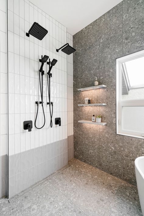 Hella Design Studio | Calgary Interior Design This shower has everything we're looking for! Marble shelves with lighting! A modern look for grey terrazzo shower walls and floor! Black his and hers shower fixtures! And handmade look white and grey subway tiles vertically stacked. We love to see it!!!! 📷: @heymjay Light Grey Terrazzo Bathroom, Terrazzo Shower Wall, Grey Terrazzo Bathroom, Bathroom Tiles Grey White, Handmade Subway Tile, Small Space Bathroom Design, Terrazzo Bathroom, Black And White Tiles Bathroom, Grey Wall Tiles