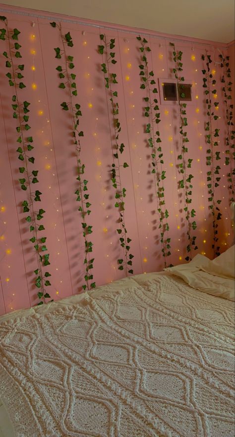 pink walls of bedroom with ivy vines and curtain fairy lights alternating with white bed comforters Pink Room With Vines, Pink Wall Curtain Ideas, Pink Walls Aesthetic, Vine And Fairy Lights Wall, Bedroom With Pink Walls, Aesthetic Teen Bedroom, Aesthetic Vines, Bedroom Ivy, Curtain Fairy Lights