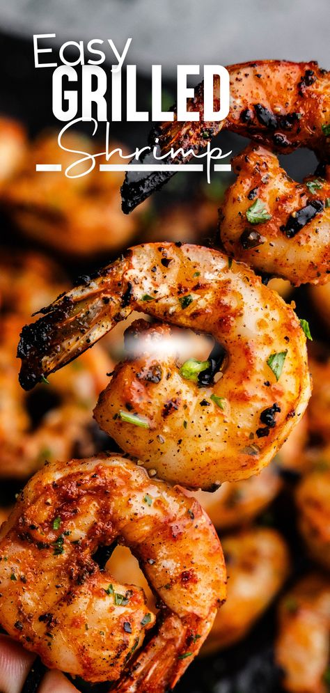 A skewer of grilled curly shrimp with the tails on being held above a pan of skewered shrimp. Shrimp On Bbq Grill, Grilled Shrimp Recipes For Dinner, Broiled Shrimp Oven, Simple Grilled Shrimp, Shrimp On The Grill, Grilling Shrimp, Cooking Raw Shrimp, Grilled Jumbo Shrimp, Grill Shrimp