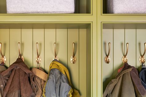 A detail image of brass coat hooks on olive green painted panelling Hetherington Newman, Bespoke Cabinetry, Boot Rooms, Green Lacquer, Bespoke Dining Table, Brass Coat Hooks, Coat Pegs, Shaker Style Cabinets, Oak Dresser