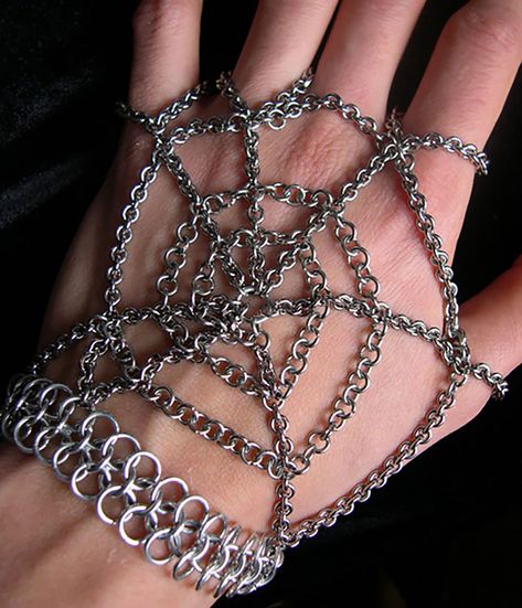 From my personal collection: a spiderweb handflower! 🕷️🕸️ I'm not sure exactly when I made it, but the photo is dated Sept 2004... so it's definitely an oldie! It uses a thicker style of rhodium-plated chain I haven't used in at least 12 years; if I were to make it today, I'd definitely use thinner stainless steel. I remember this being a labor of love to get all the chains the perfect lengths, but I love how it turned out, and I still have it today! #halloweenjewelry #chainmaille #handflow... Spiderweb Chain, Alt Diys, Hozier Concert, Whimsical Gothic, Chainmail Patterns, Blue Buddha, Crochet Bracelets, Exhibition Ideas, Wire Crochet Jewelry