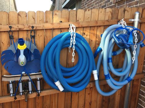 Coat hooks, bungees and plastic chains make for tidy pool equipment storage. Pool Towel Storage, Pool Organization, Piscina Diy, Pool Float Storage, Pool Toy Storage, Pool Landscape Ideas, Pool Shed, Pool Storage, Living Pool