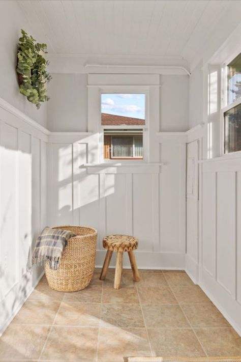 Enclosed Porch with Wainscot - It’s the place to wipe wet paws, pull off boots, start seedlings, or treat houseplants to some sunshine from the south-facing windows overlooking the back yard. #enclosedporch #backporch #mudroom #whitewainscot #whiteenclosedporch #tacomahomes #dugganhomes Enclosed Porch Mudroom Entryway, Side Porch Into Mudroom, Enclosed Mudroom Porch, Enclosed Porch Mudroom, Closing In Porch For Mudroom, Porch To Mudroom Conversion, Mudroom With Transom Window, Small Enclosed Porch, Build A Garage