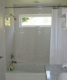 Transom window above bathtub area to allow natural light into a ... Window Above Tub, Bathroom Windows In Shower, Bathroom Window Treatments, Simple Bathroom Remodel, Bathroom Remodel Cost, Budget Bathroom Remodel, Window In Shower, Small Bathroom Renovations, Bathtub Remodel