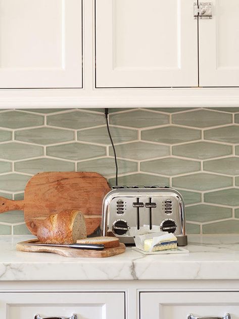 The traditional white kitchen gets a dash of color in the misty-green backsplash. The modern shape of the horizontal tiles is a bit unexpected, but the color is pulled directly from the gray-green graining in the marble countertop. Elongated Hexagon Tile, Hexagon Tile Backsplash, Backsplash Tile Design, Green Backsplash, Herringbone Backsplash, Kitchen Backsplash Designs, Subway Tile Backsplash, Classic Kitchen, Up House