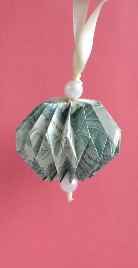 The money toy (ball) is an easy origami for your Christmas tree. We need two dollar bills, a satin ribbon, beads. Without glue or tape. The idea and design by Anastasia Prokuda. I wish you a pleasant viewing! Subscribe to my channel! Dollar Bill Christmas Origami, Money Tie How To Make A, Money Ornaments Diy, Money Oragami Ideas, Folded Dollar Bills Easy, Origami Using Money, Dollar Christmas Tree, Money Christmas Tree, Money Ornaments