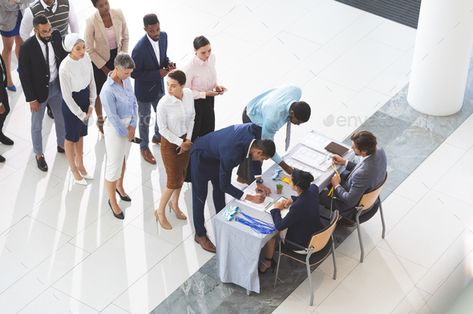 High angle view of diverse business people checking in at conference registration table in lobby by Wavebreakmedia. High angle view of diverse business people checking in at conference registration table in lobby #Affiliate #diverse, #business, #people, #High Table In Office, Conference Registration, Registration Table, Office Lobby, High Angle, Business People, Lobby